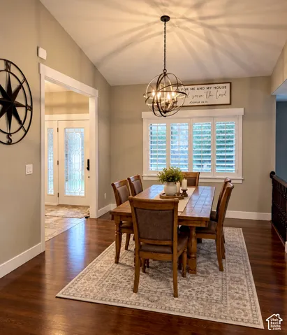 Vaulted ceilings, wood-finish flooring, orb-style pendant lighting, and plantation shutters
