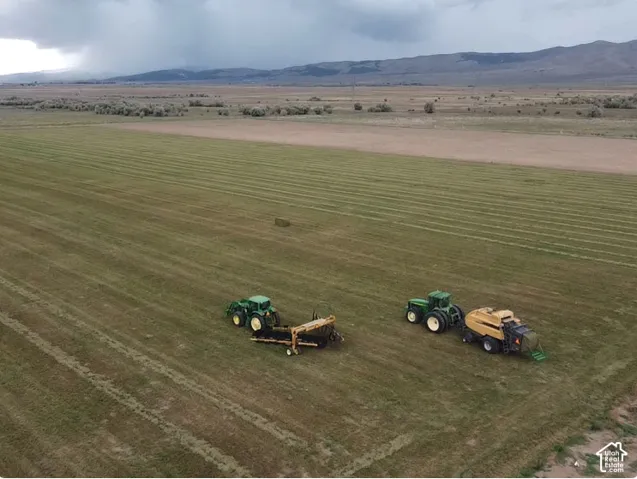 Expansive agricultural acreage featuring vast pastoral plains and mountain backdrops