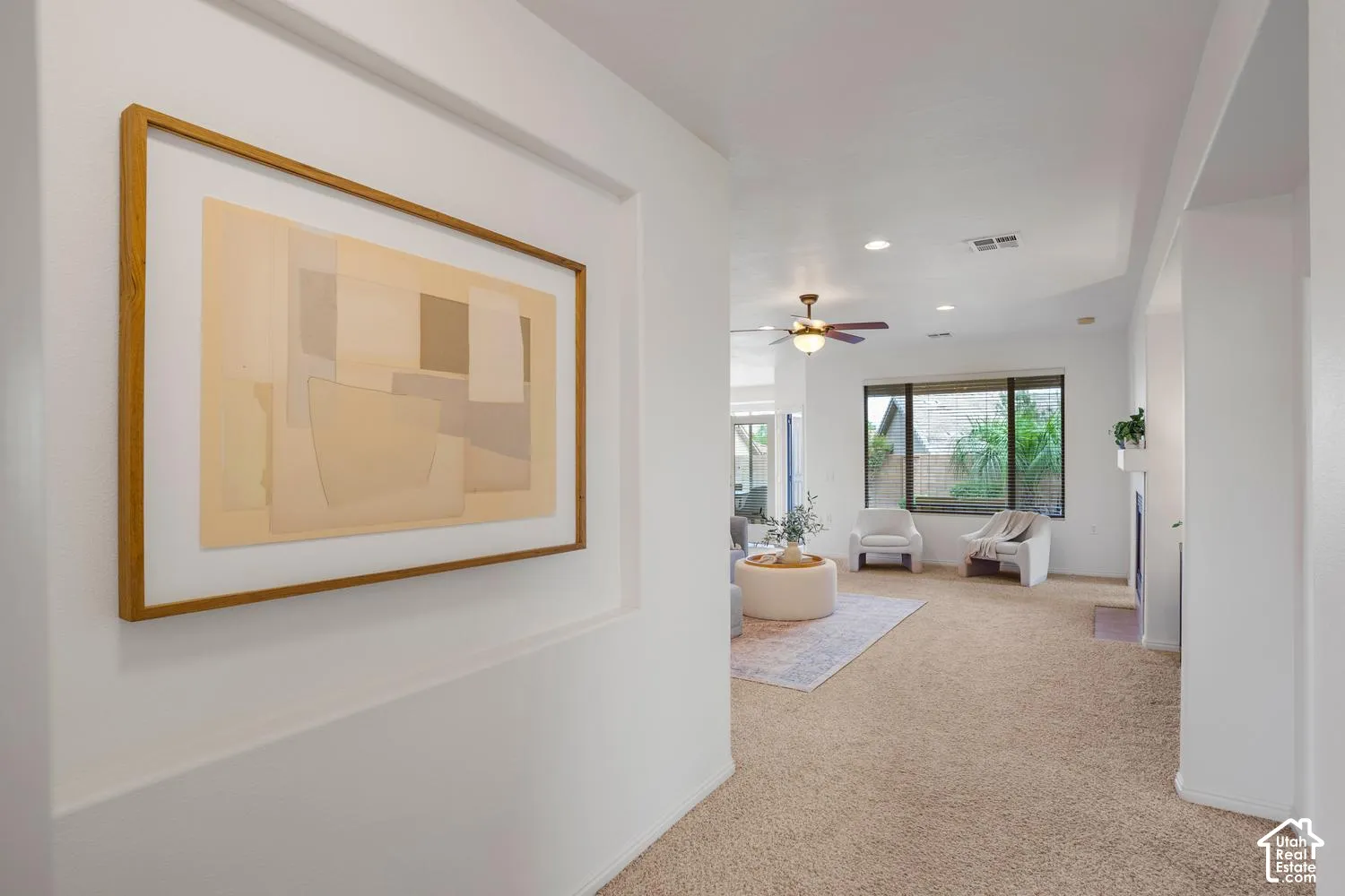 Recessed wall niche, tray ceiling, integrated ceiling fan, and large picture window