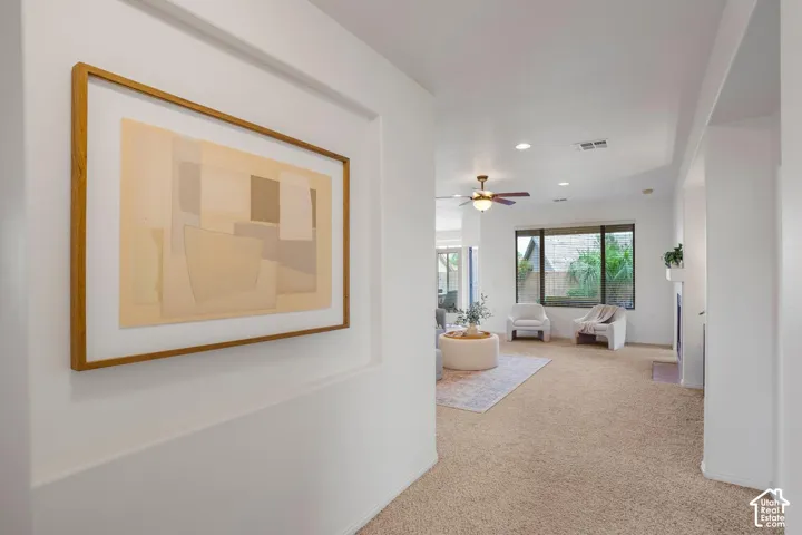 Recessed wall niche, tray ceiling, integrated ceiling fan, and large picture window
