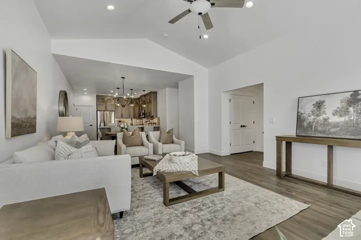Vaulted ceilings, wood-finish flooring, recessed lighting, ceiling fan, and double-door entry