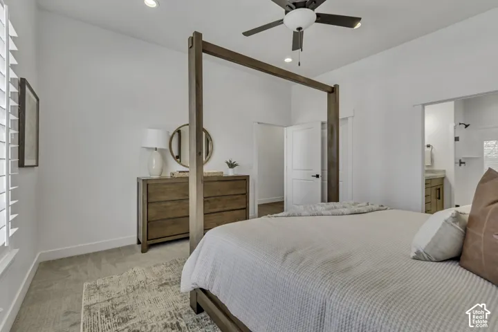 Neutral-toned wall-to-wall carpeting, recessed ceiling lighting, and a multi-blade ceiling fan with an integrated light fixture