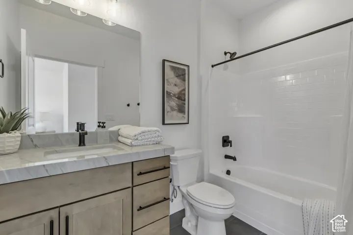 Vanity featuring a stone-patterned countertop, undermount sink, and matte black faucet