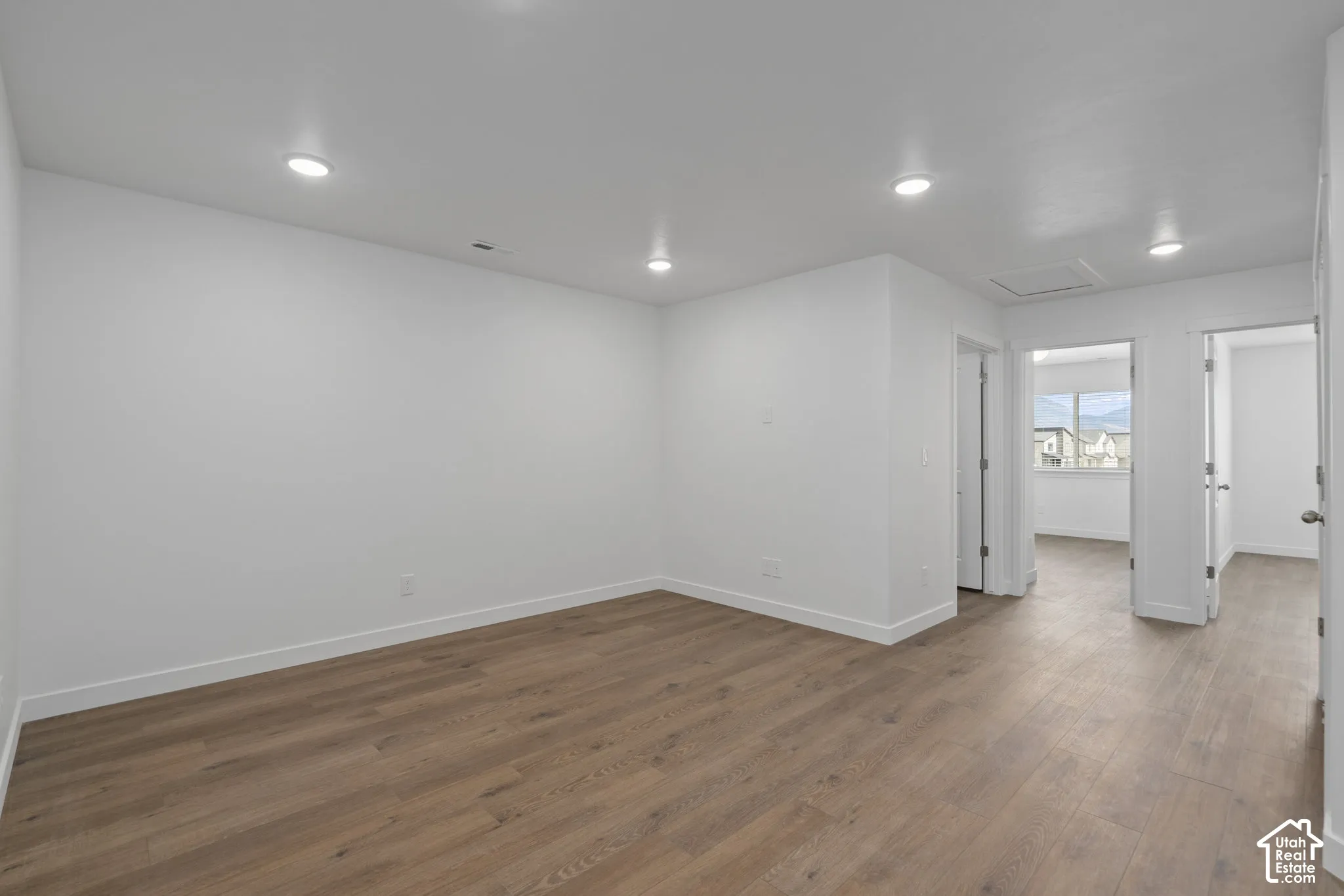 Upstairs Loft featuring LVP wood-finish flooring, recessed lighting, and neutral wall paint
