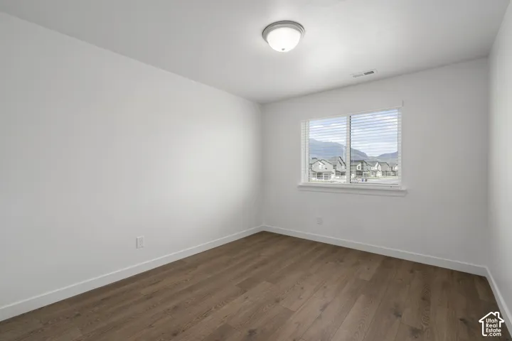 Interior space featuring LVP wood-finish flooring, a neutral color palette, a single-pane window, and a ceiling-mounted light fixture