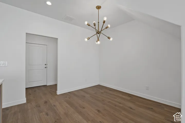 Interior space featuring LVP wood-finish flooring, and multi-arm brass chandelier