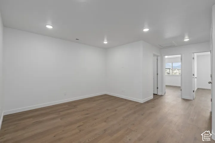 Upstairs Loft featuring LVP wood-finish flooring, recessed lighting, and neutral wall paint