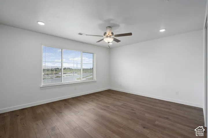 Primary Bedroom Neutral-toned interior featuring LVP wood-finish flooring, a central ceiling fan with an integrated light fixture, recessed lighting, window with horizontal blinds