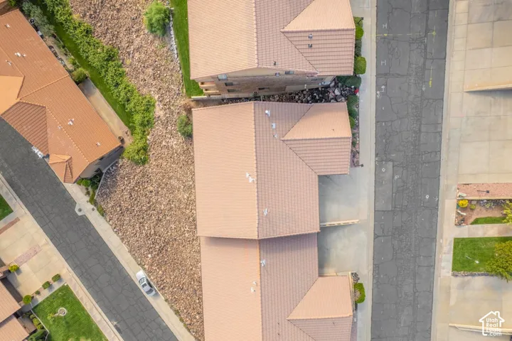 Aerial perspective featuring tile roofing, concrete driveways, and low-maintenance rock landscaping