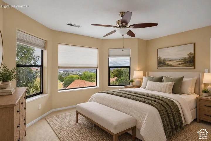 Bay window featuring black-framed windows, neutral carpet, and a ceiling fan with integrated lighting