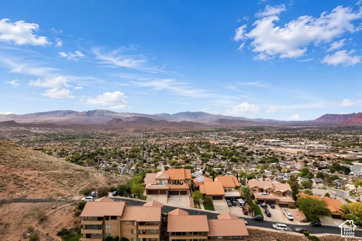 Aerial perspective featuring multi-story residential structures with tile roofing and panoramic mountain scenery