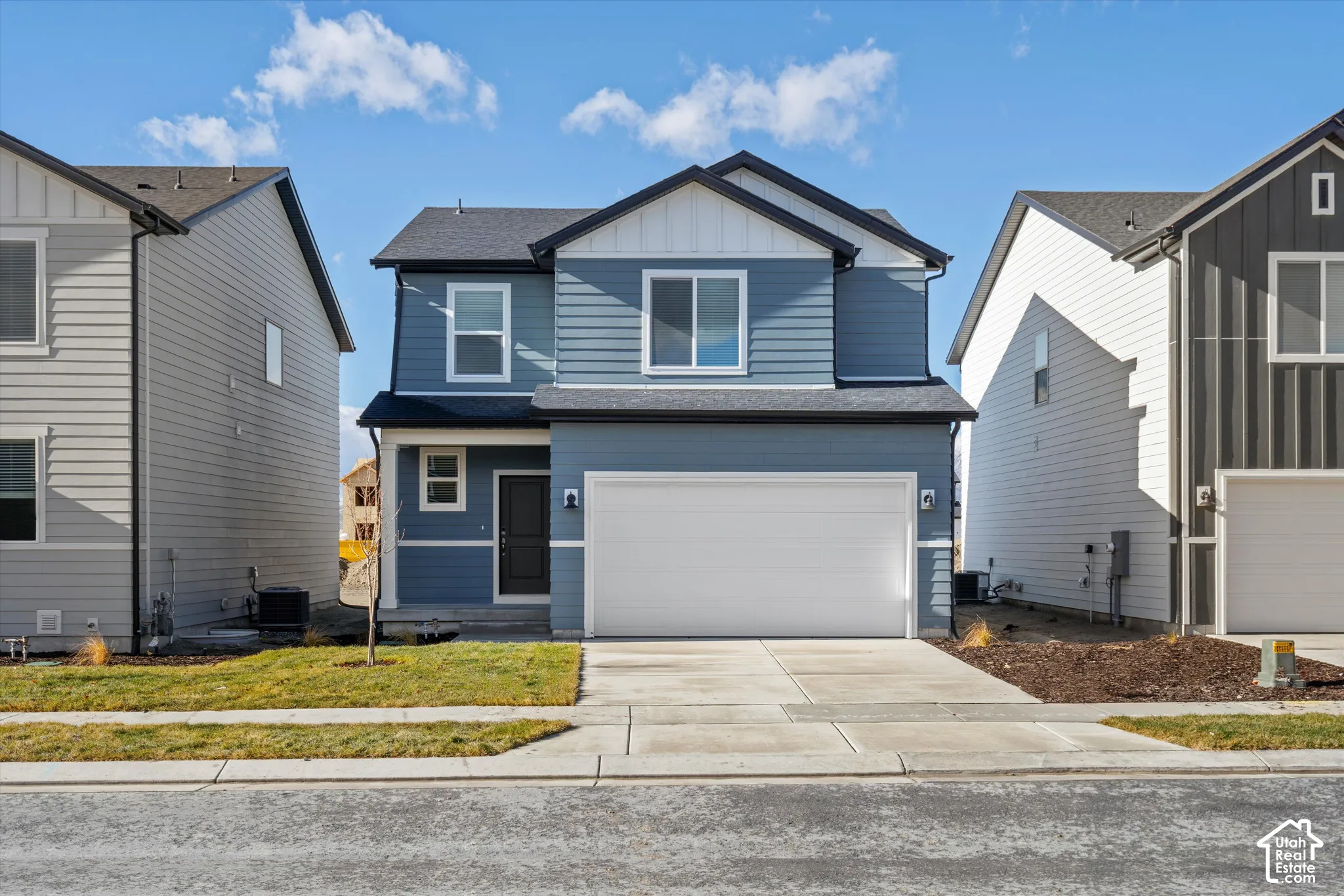 *DISCLAIMER* Elevation and exterior color may vary. Two-story exterior featuring horizontal lap siding, a front-facing gable roofline, decorative board-and-batten gable detailing, an attached two-car garage, and a concrete driveway
