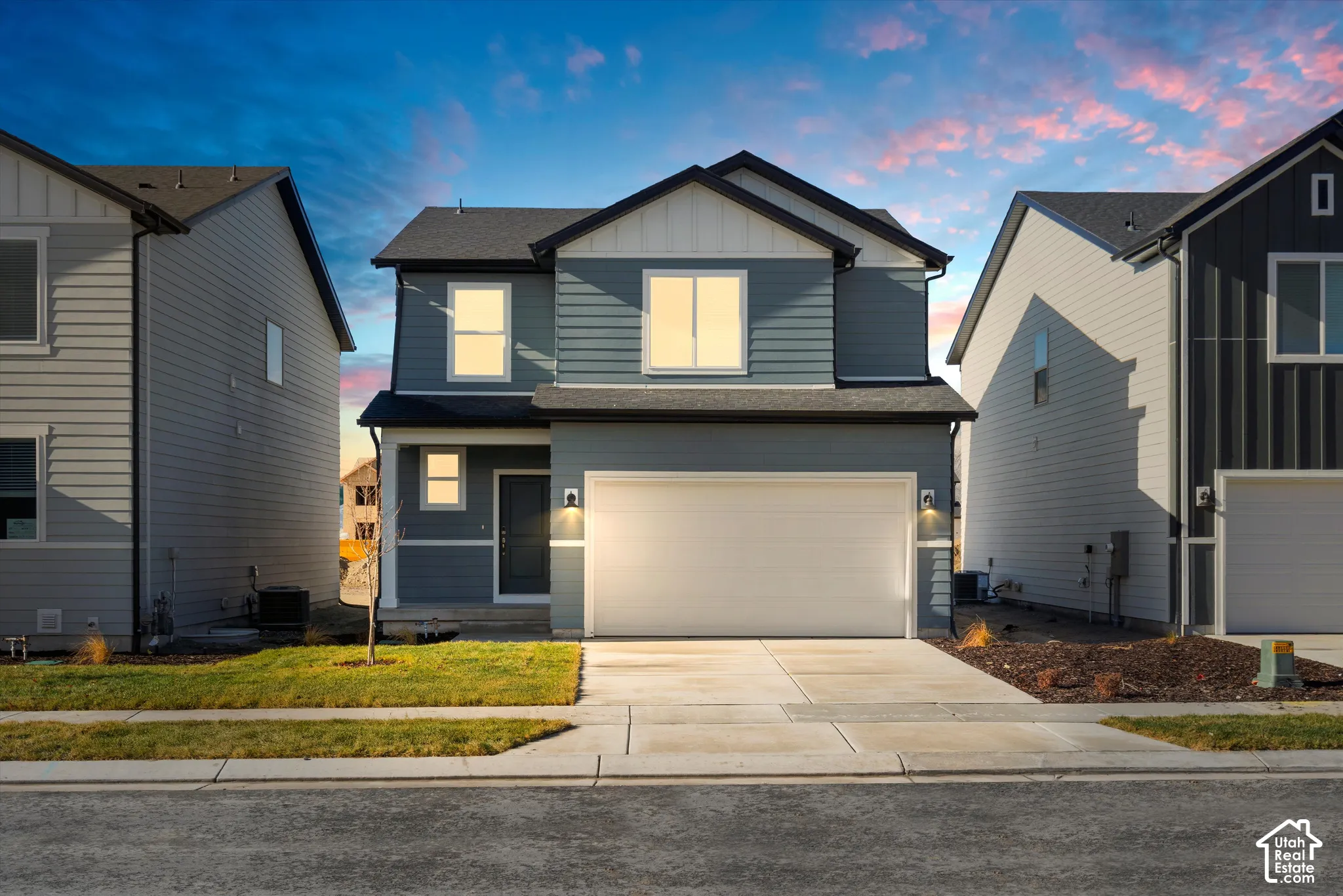 *DISCLAIMER* Elevation and exterior color may vary. Two-story residence featuring horizontal lap siding, a pitched roofline, an attached two-car garage, and concrete driveway