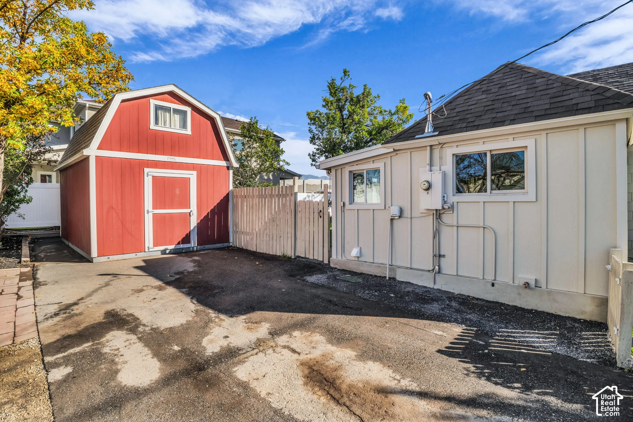 Red barn-style shed with white trim