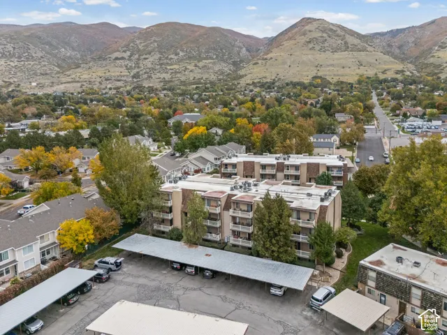 Multi-level residential complex featuring private balconies, designated covered parking, and proximity to mountain scenery