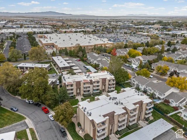 Multi-story residential buildings featuring stucco exteriors, private balconies, and asphalt shingle roofing