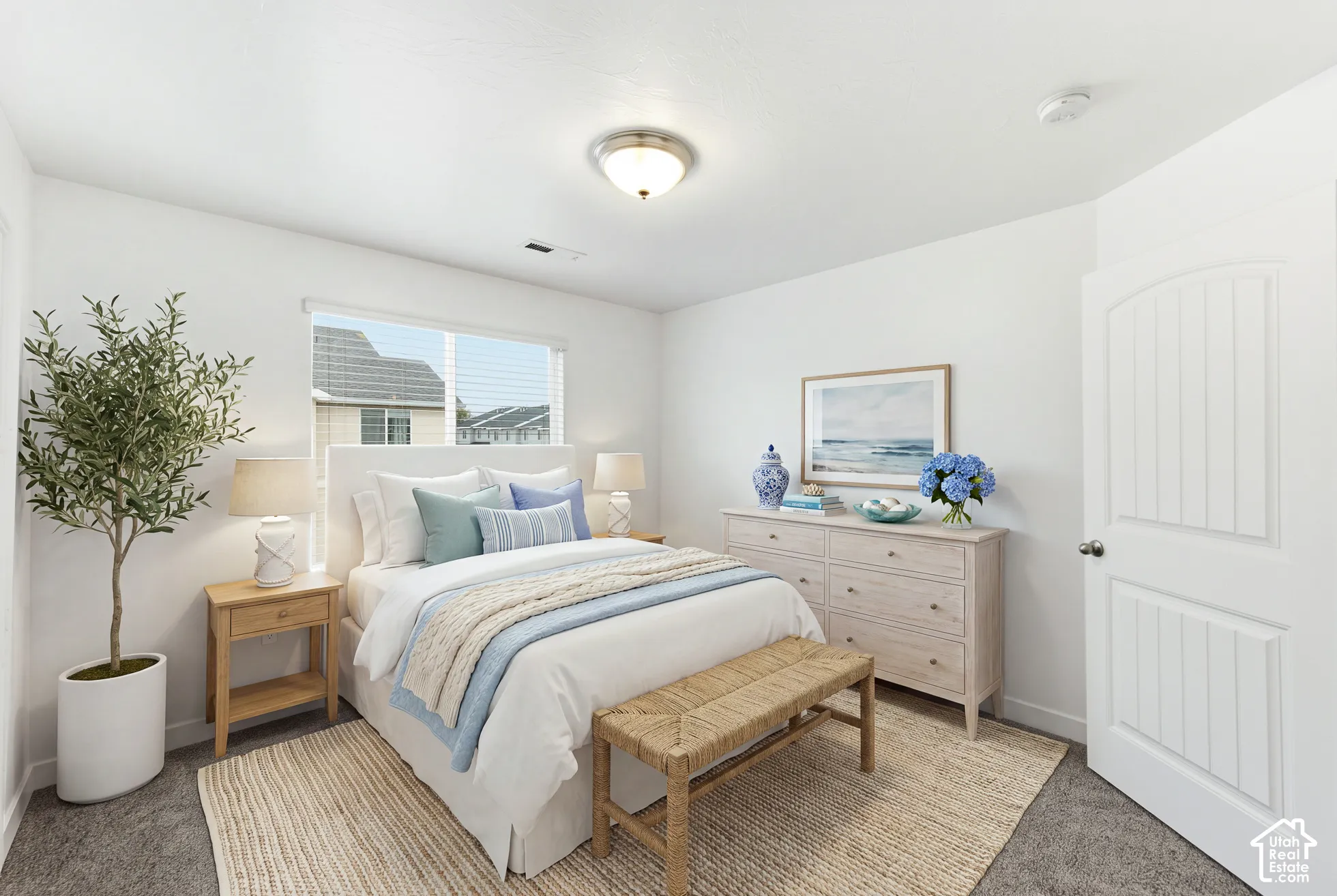 Neutral wall color, carpeted flooring, window with natural light, and an arched-panel interior door