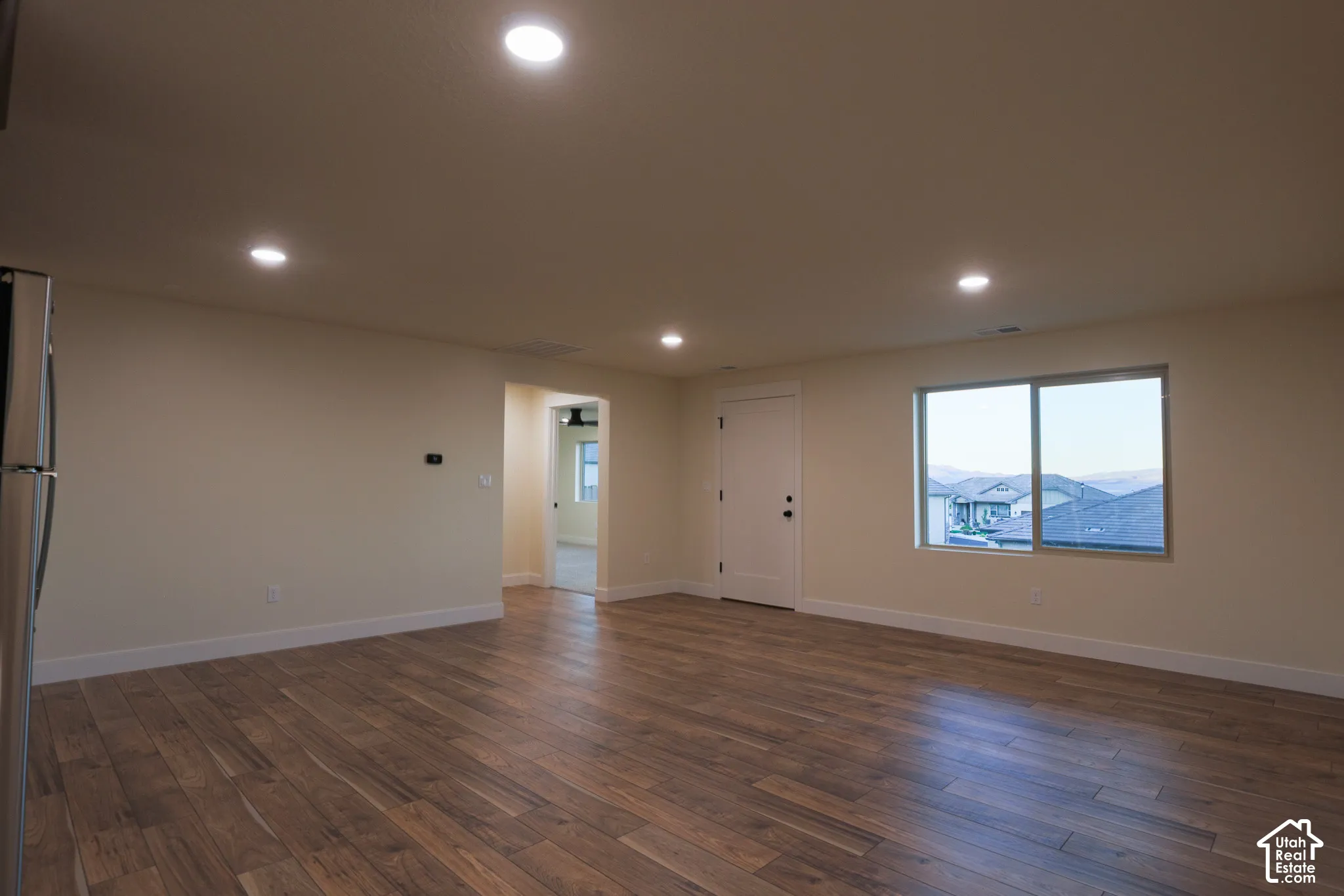 Interior room featuring wood-finish flooring, recessed lighting, and a large window