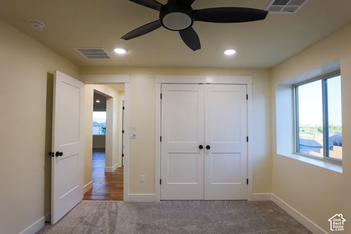 Room featuring neutral walls, recessed lighting, a modern ceiling fan, wall-to-wall carpeting, and white interior doors