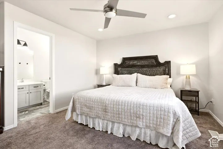 Main-floor primary bedroom with natural light, and an adjoining primary bathroom.