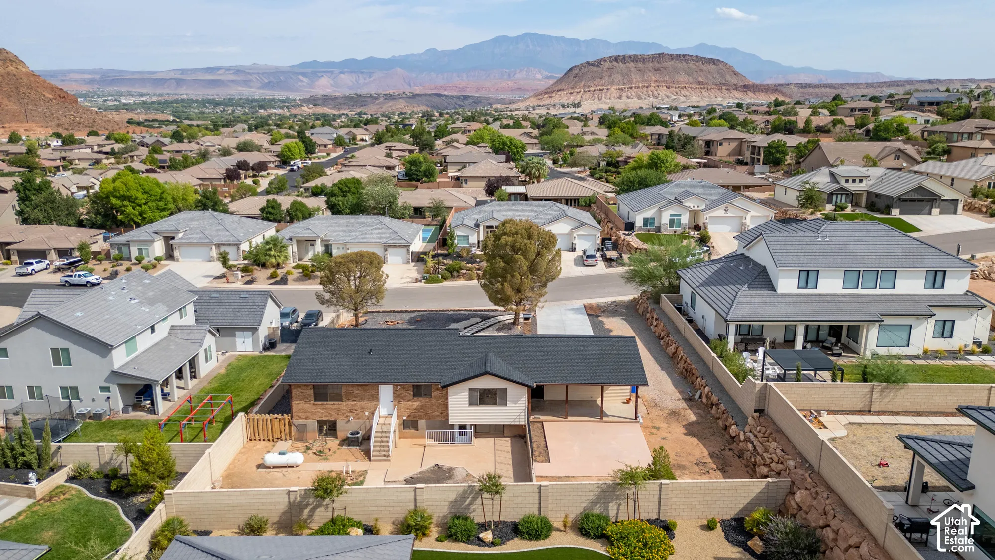 Expansive property featuring a flat roof and a large, uncovered patio area