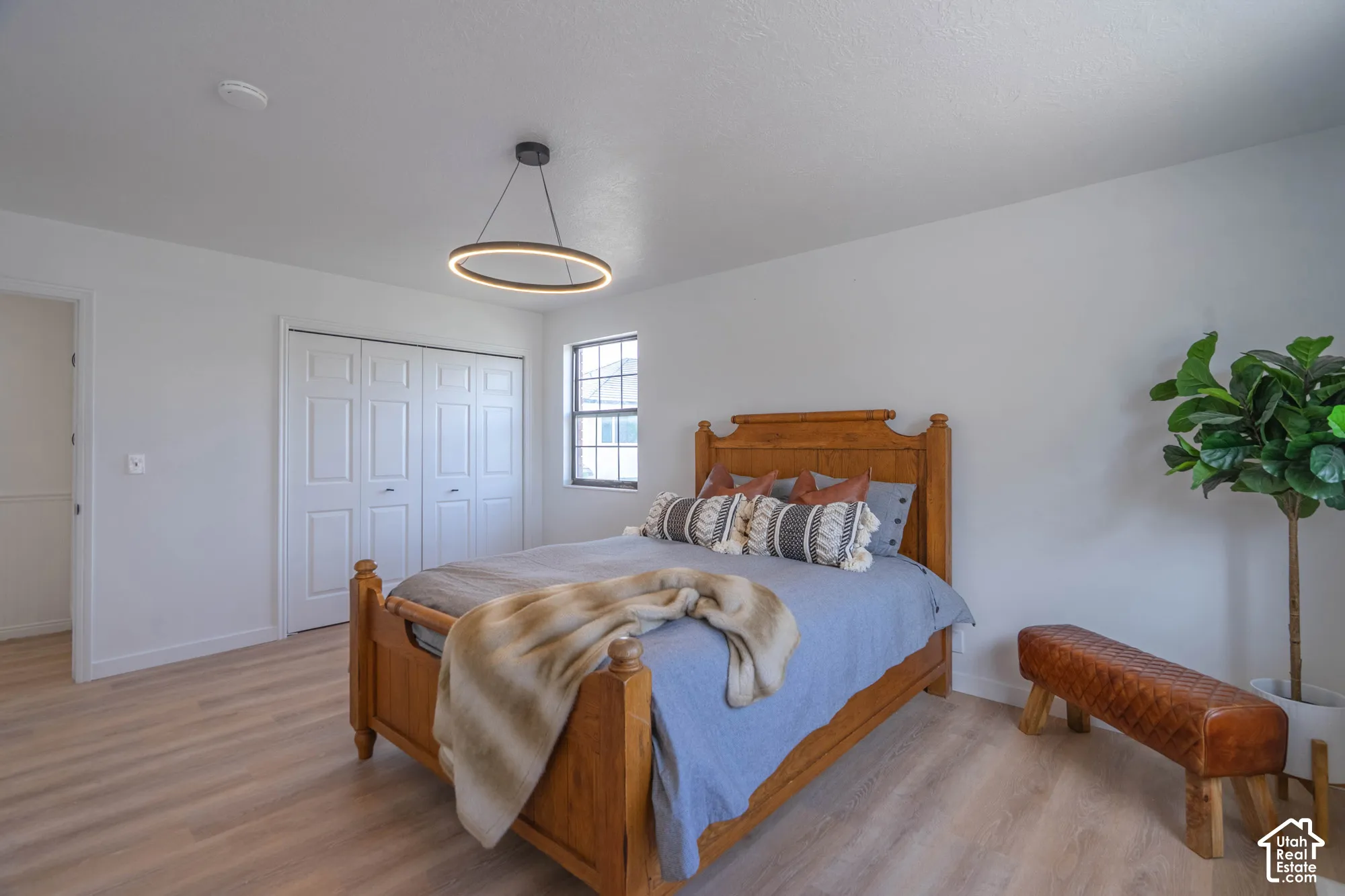 Light wood-finish flooring with white walls