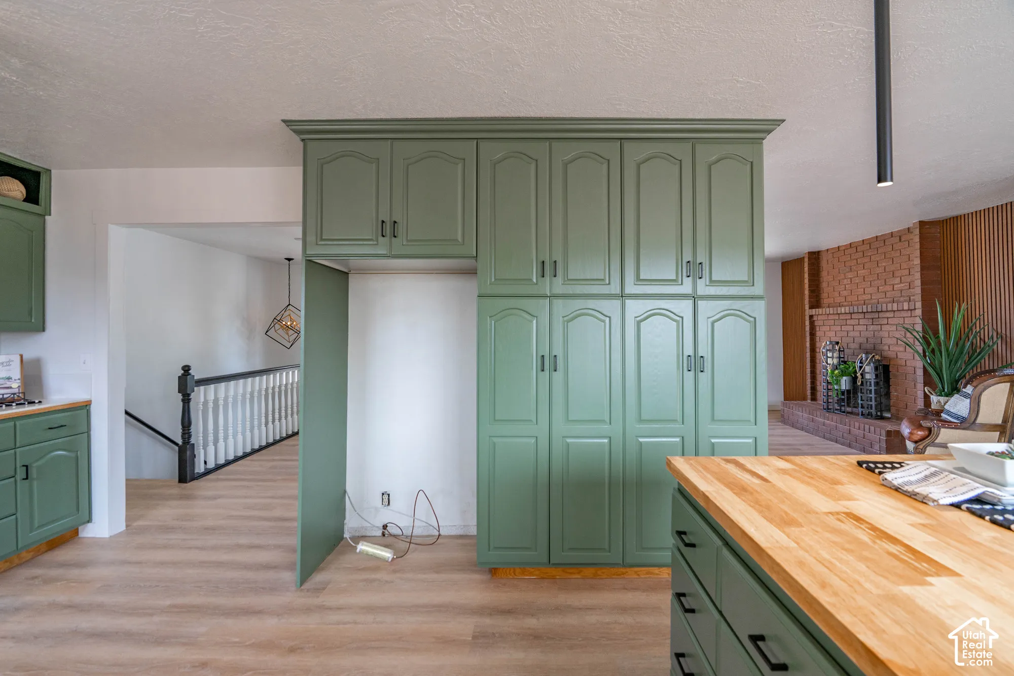 Kitchen featuring ample built-in cabinetry, wood-finish flooring, and wood countertops