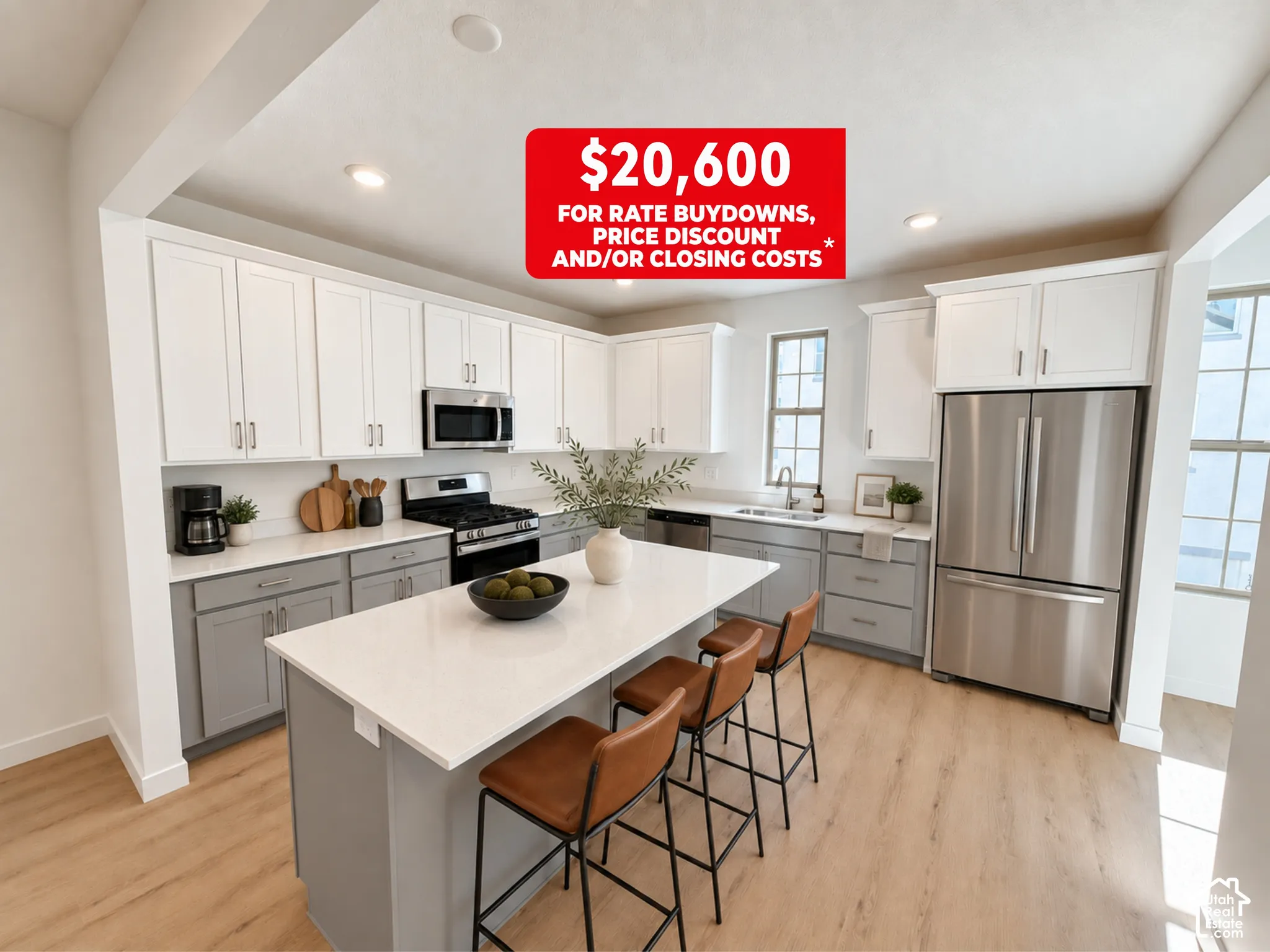Kitchen featuring dual-tone cabinetry, central island with light-toned solid surface countertop, stainless steel appliances, and wood-finish flooring