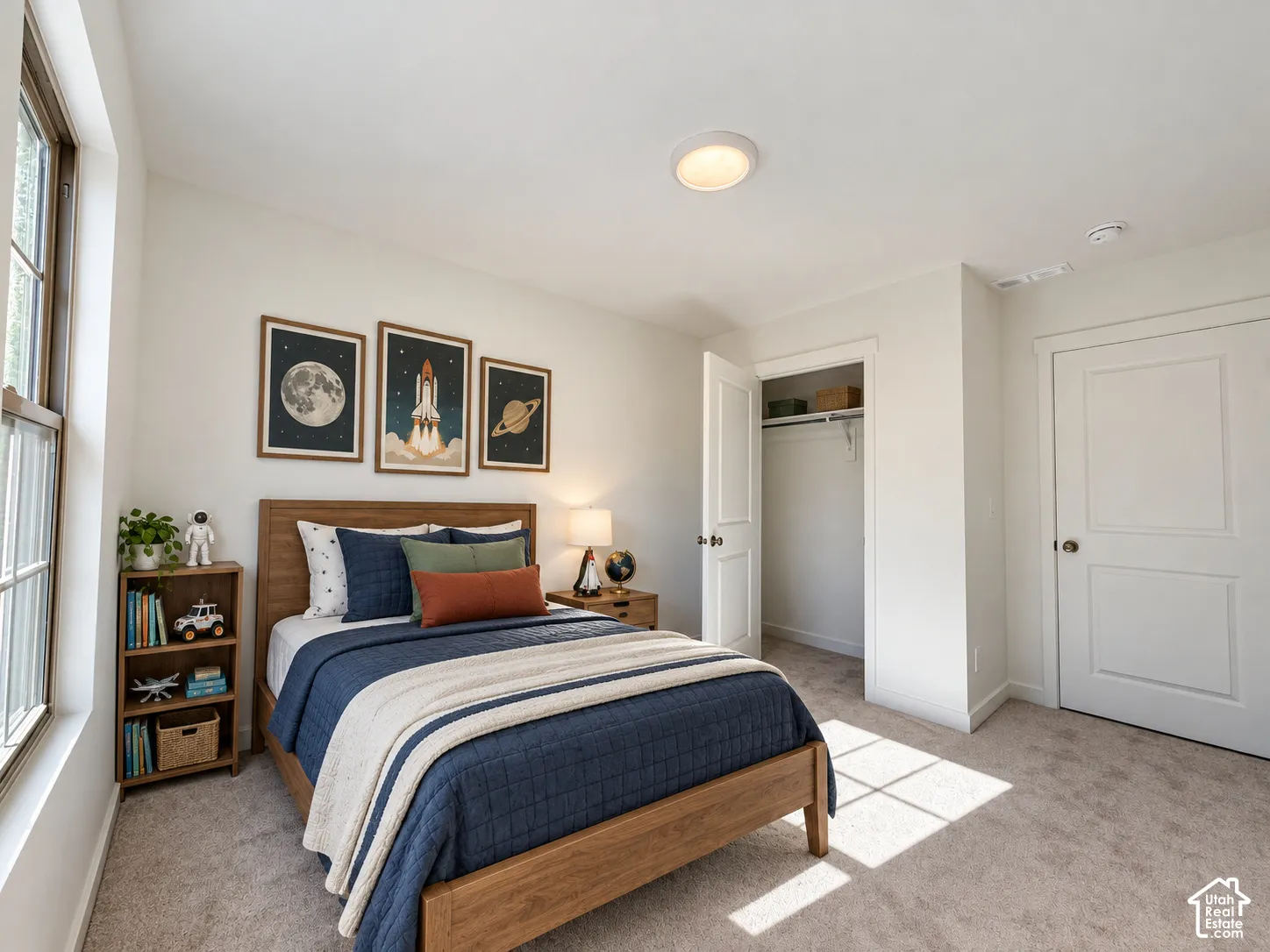Neutral-toned wall-to-wall carpeting, single-hung window with casing, flush-mount ceiling lighting, and walk-in closet with integrated shelving