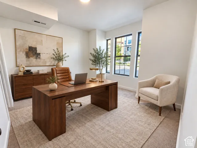 Neutral-toned walls paired with expansive windows featuring dark frames and wall-to-wall carpeting