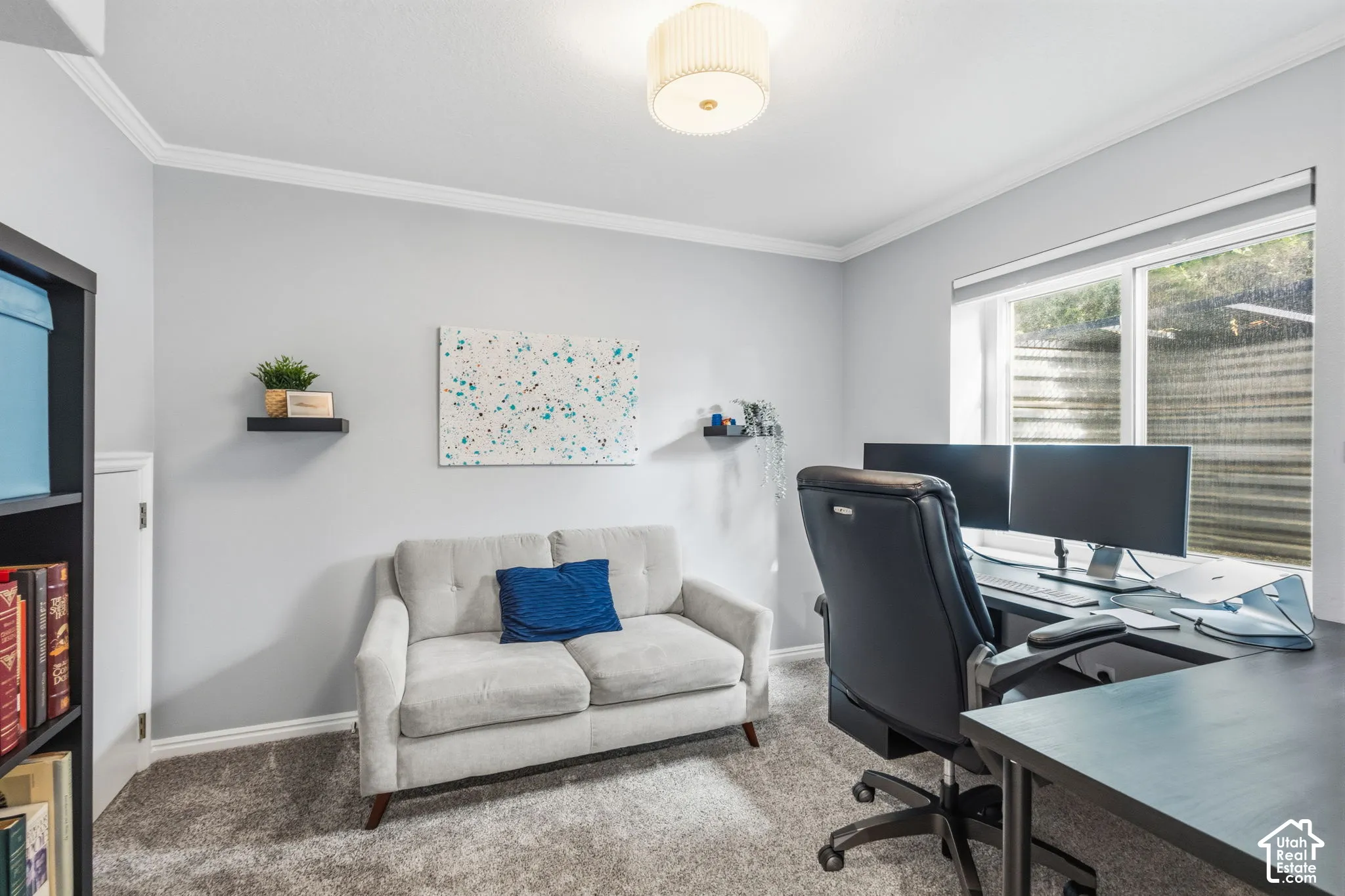 Neutral wall tones, crown molding, wall-to-wall carpeting, and a flush-mount drum light fixture