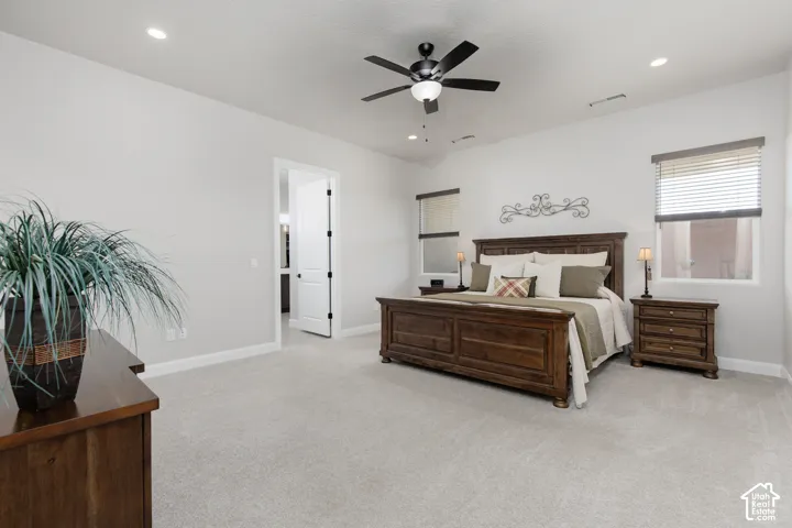 Neutral-toned carpeted flooring, recessed lighting, and a multi-blade ceiling fan with integrated light fixture