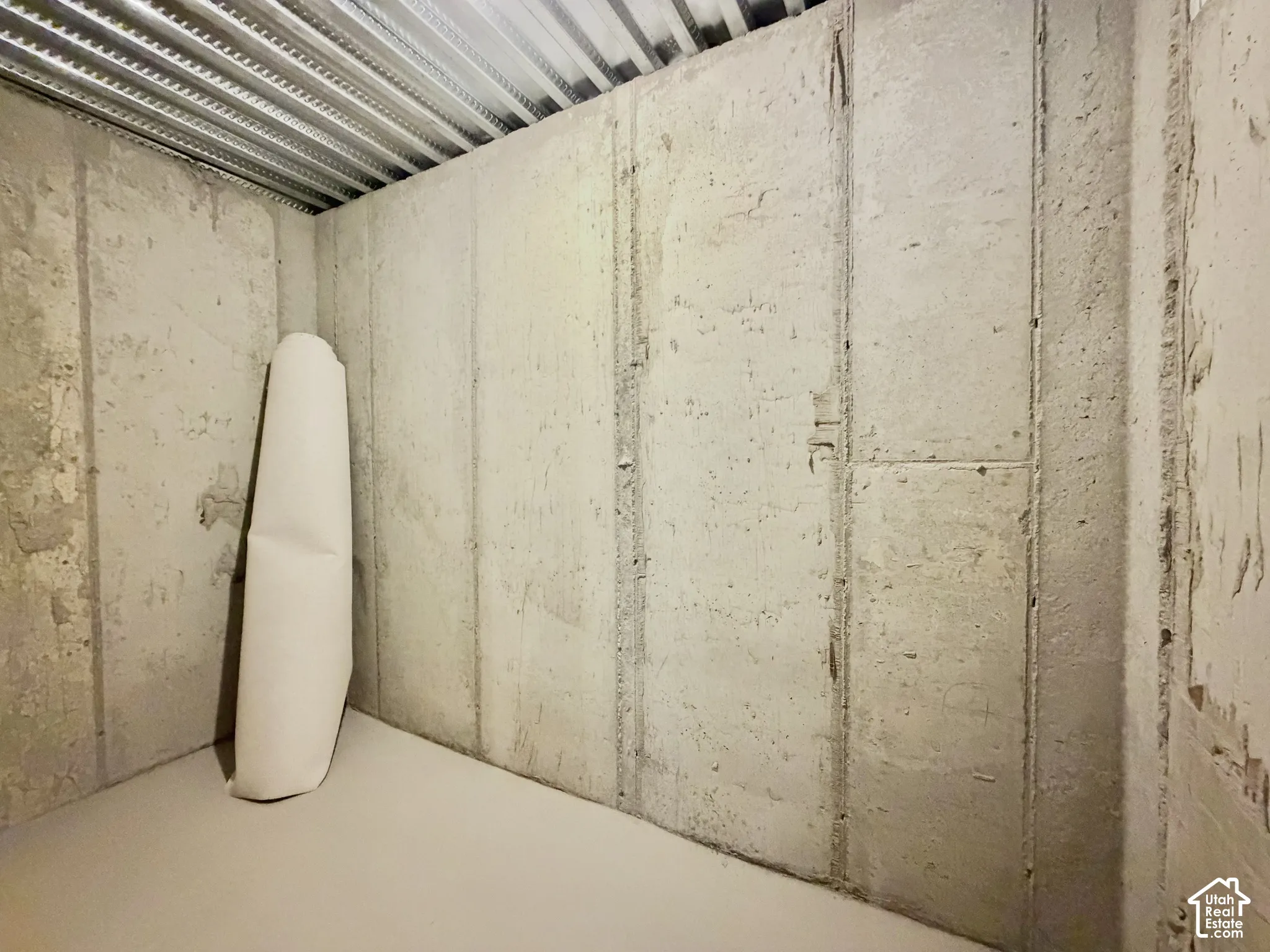 Poured concrete walls and corrugated metal ceiling