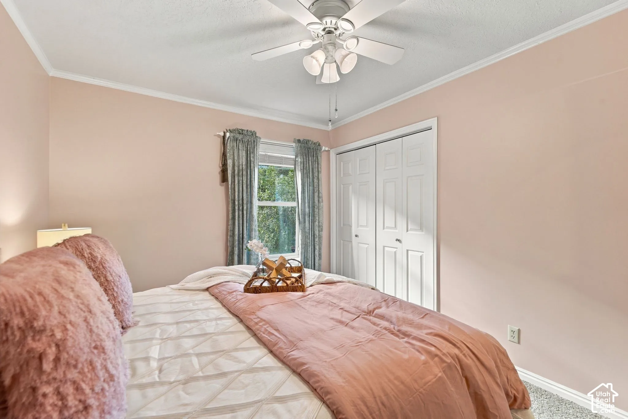 Room featuring a white ceiling fan with integrated lighting, a single window, and a white bifold closet door