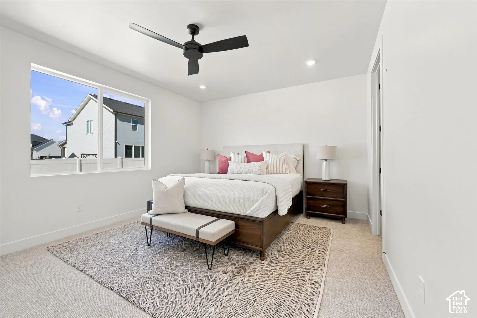 Neutral-toned interior featuring recessed lighting, a matte black ceiling fan, and a large picture window