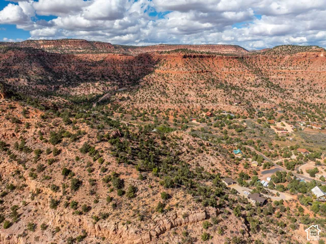 Aerial perspective showcasing rugged red rock topography, expansive desert terrain, and indigenous vegetation