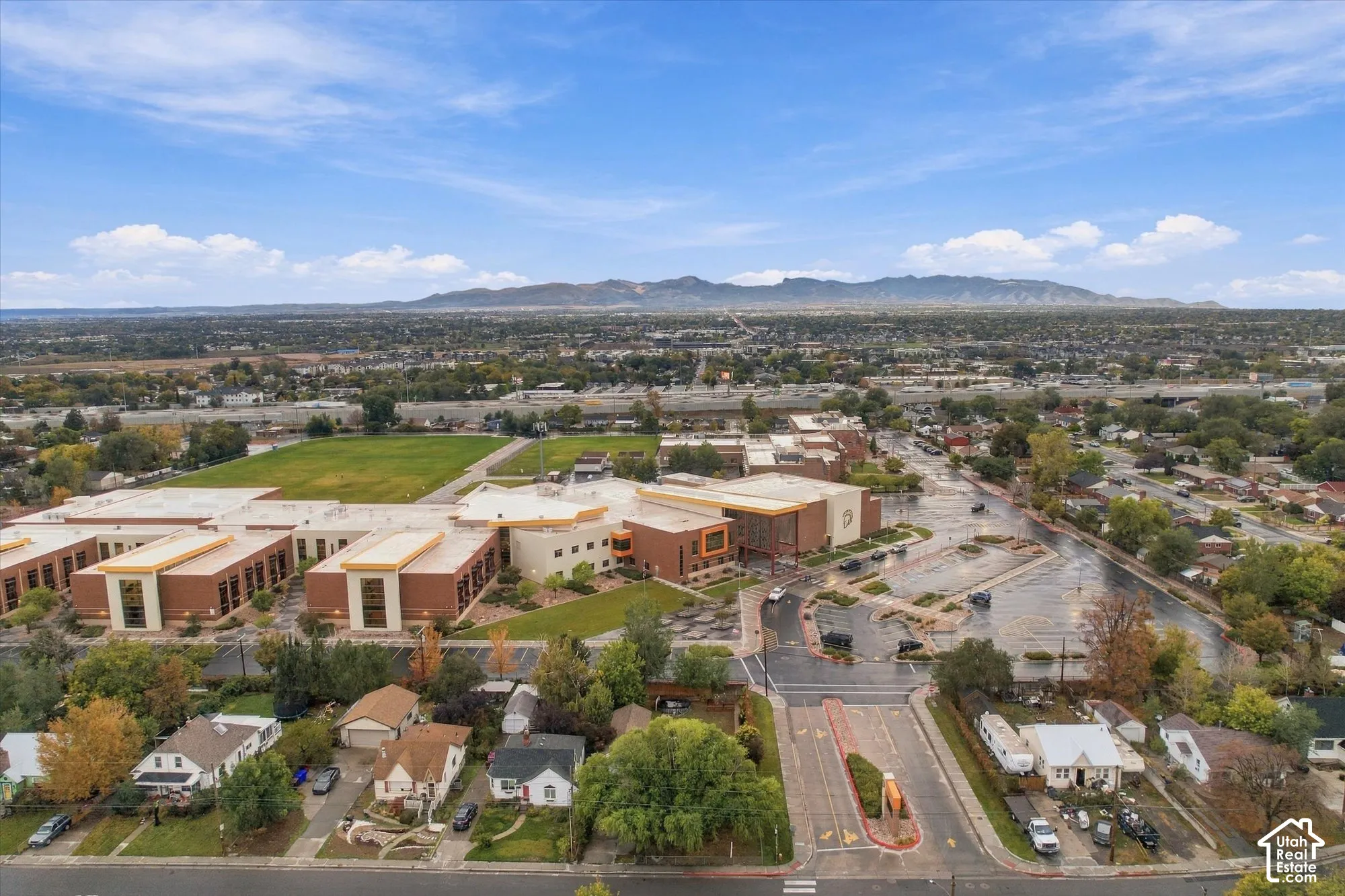 Aerial perspective featuring expansive mountain range backdrop and established residential surroundings