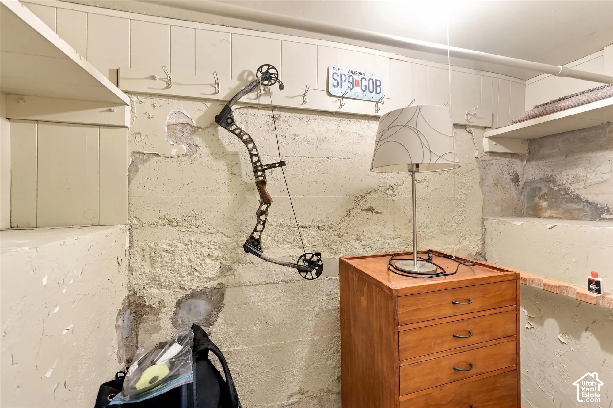 Built-in wooden shelving and integrated wall-mounted storage hooks