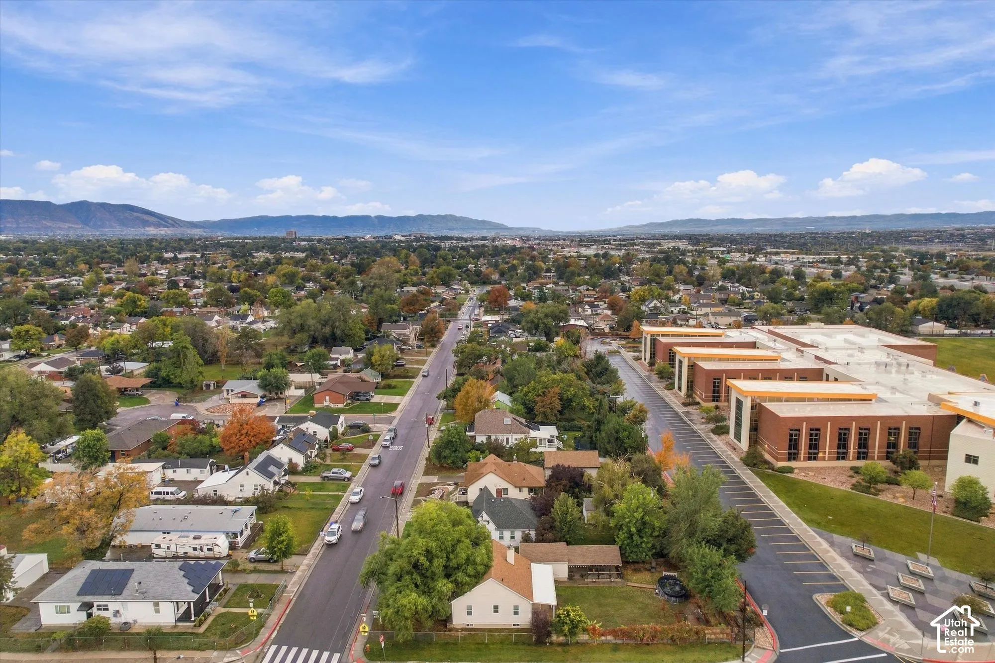 Aerial perspective featuring expansive mountain topography and established tree-lined streets