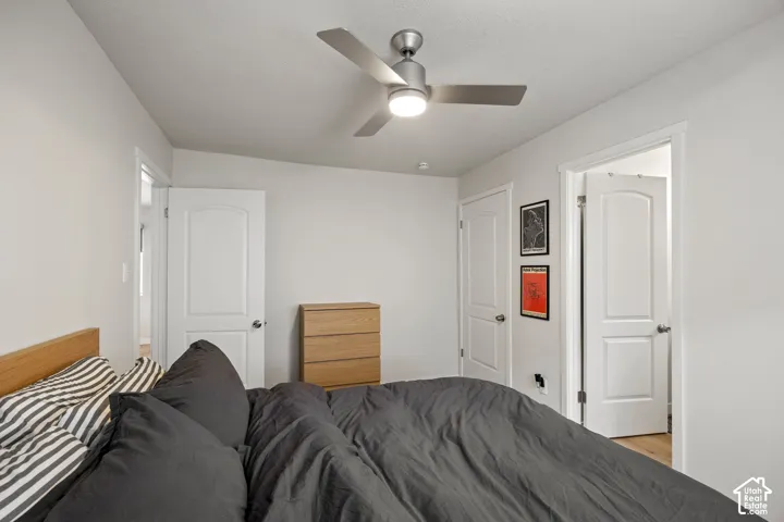 Room featuring a three-blade brushed metal ceiling fan with integrated lighting, two-panel interior doors with brushed nickel hardware, and neutral wall paint