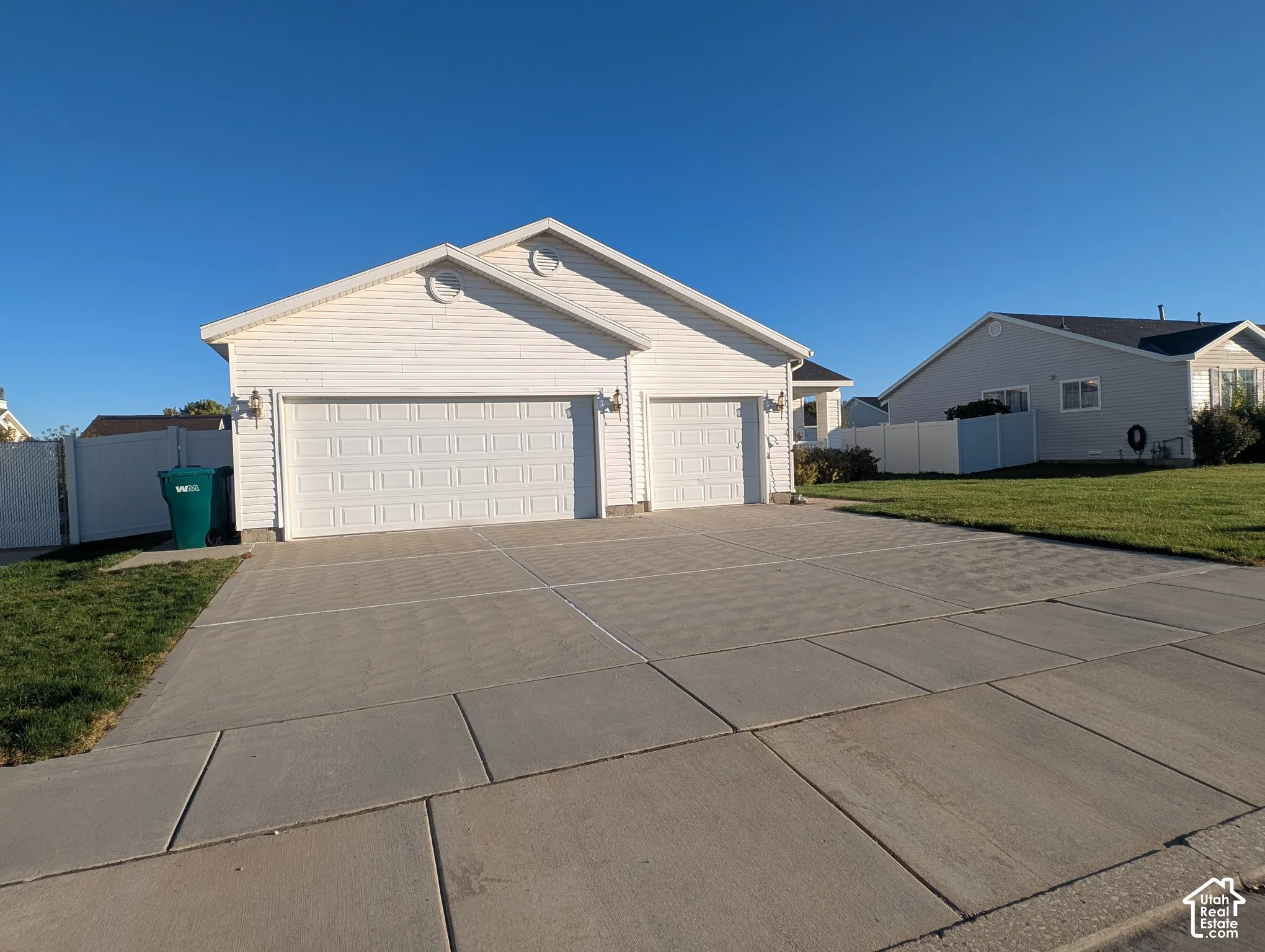Single-level residence with horizontal siding, a three-car garage, and a concrete driveway