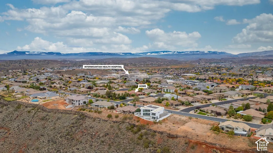 Aerial perspective featuring a residential property situated near regional mountain ranges