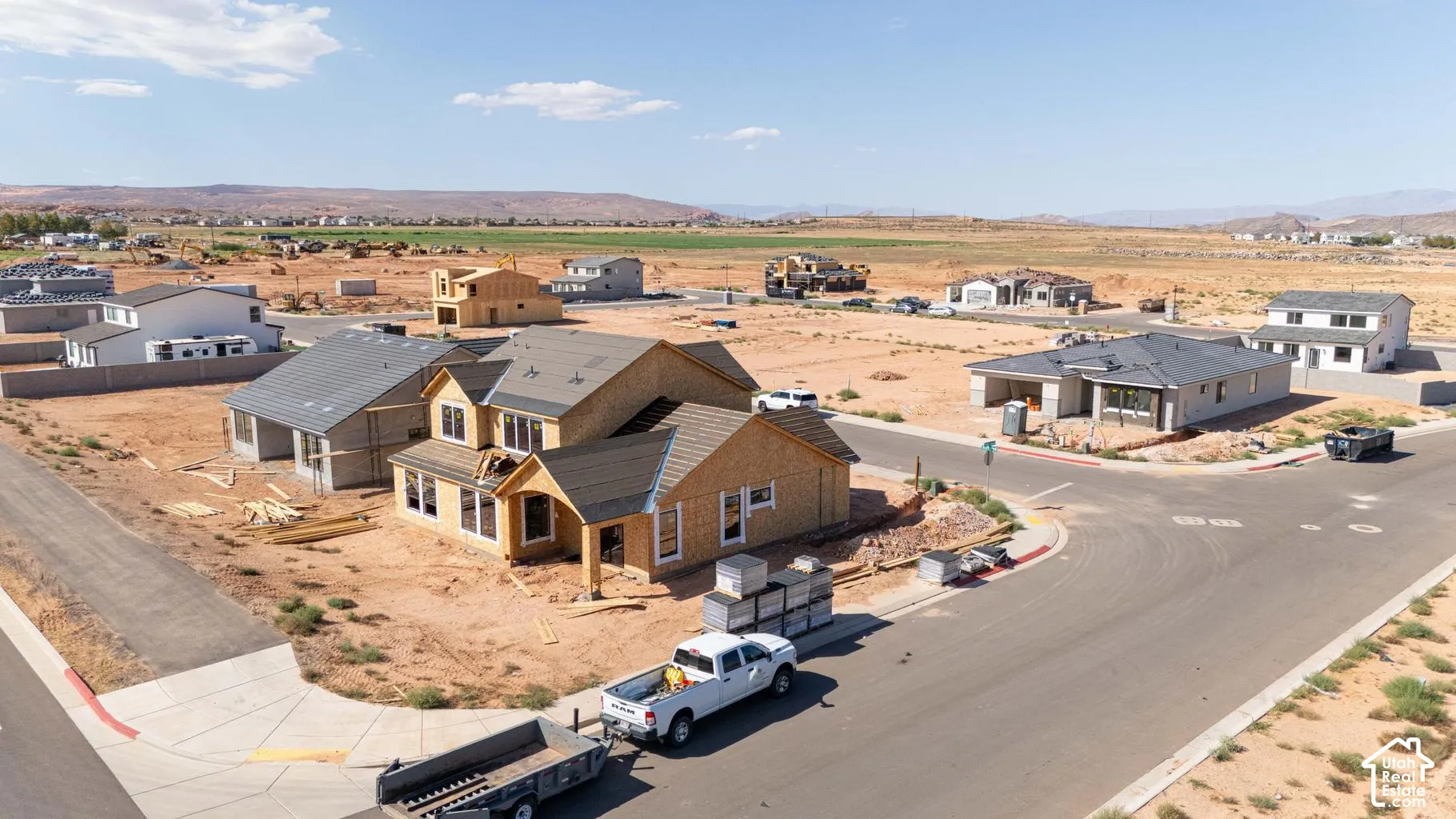 Two-story residential structure featuring a shingle roof, wood-frame construction, and paved street access