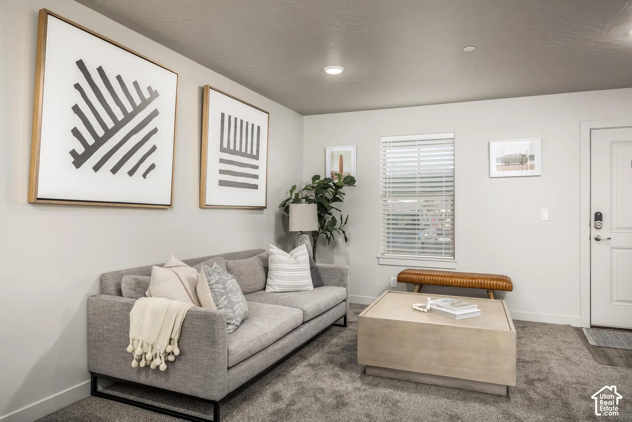 Neutral-toned interior featuring recessed lighting, carpeted flooring, and a window with horizontal blinds