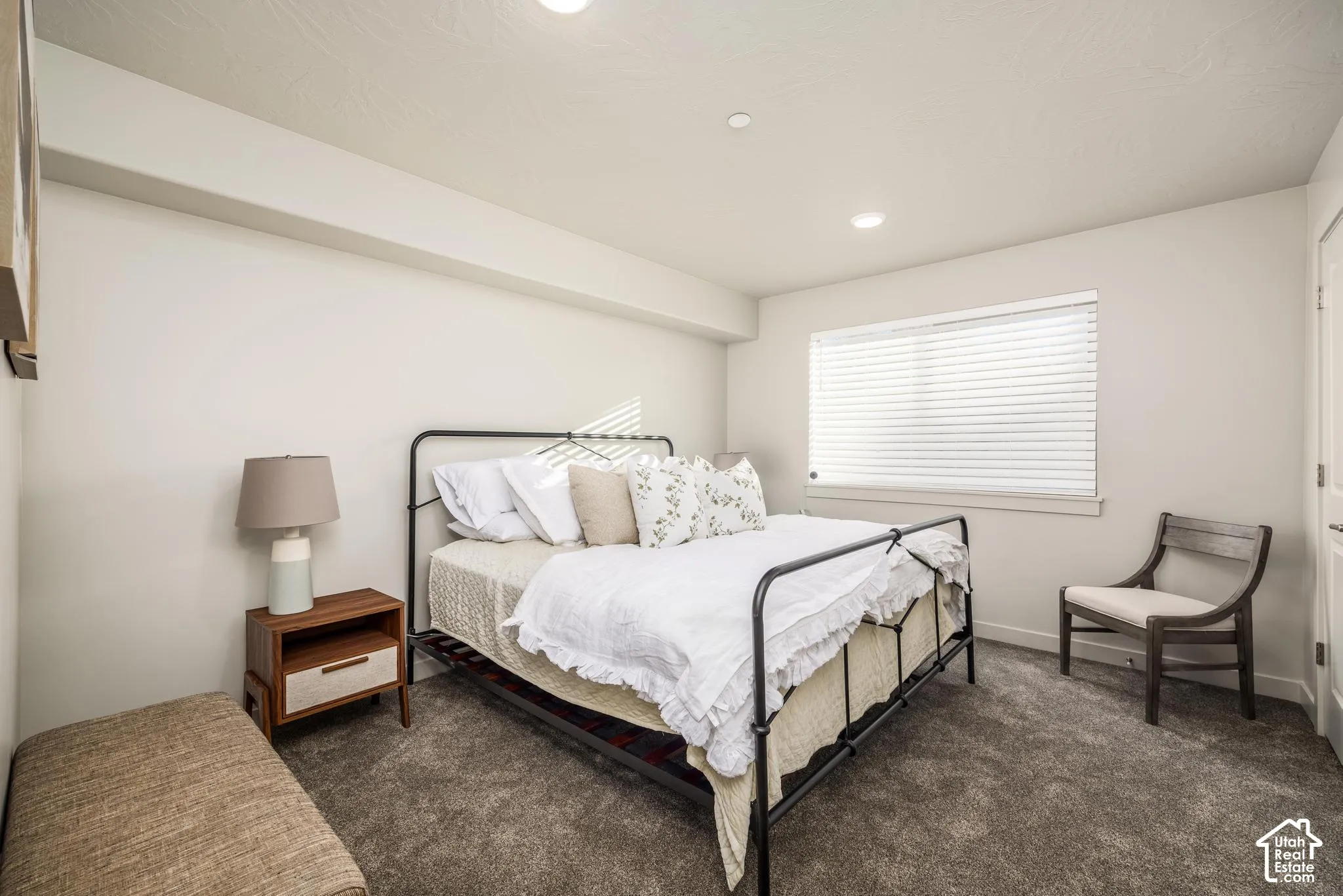 Neutral wall color, recessed ceiling lighting, carpeted flooring, and horizontal window blinds