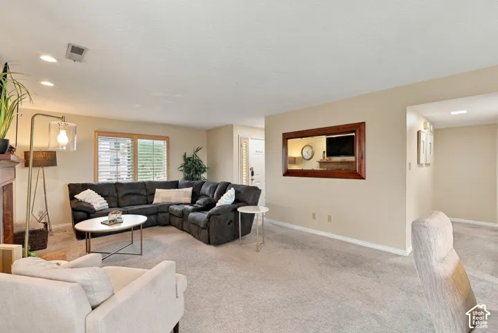 Wall-mounted interior window, recessed lighting, and large windows with wood-tone frames
