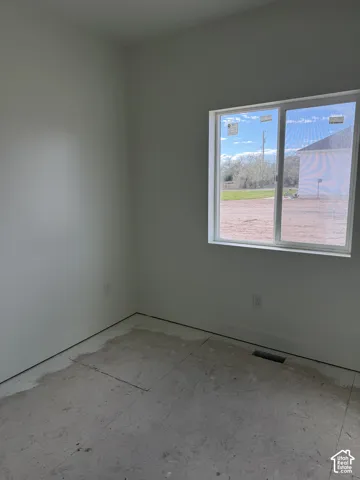 Neutral-toned interior walls and a double-pane horizontal sliding window