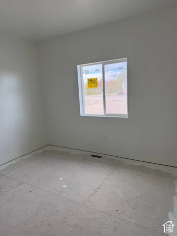 Neutral interior space featuring white-painted walls and a horizontal sliding window