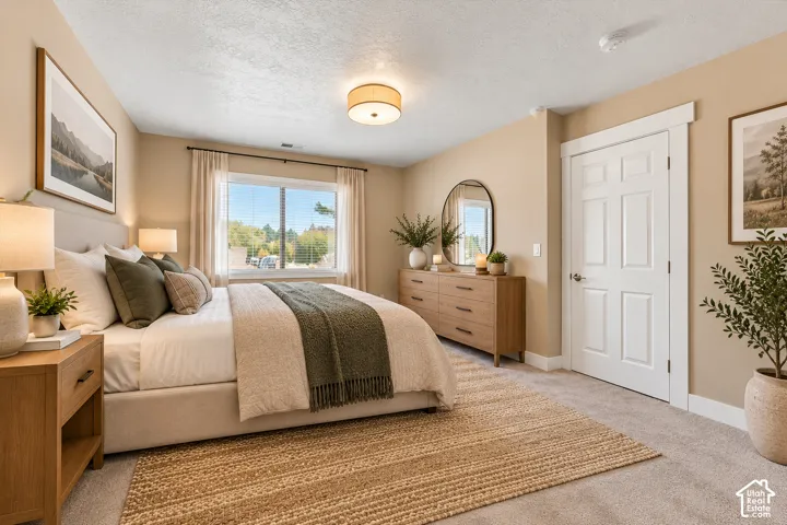 Neutral-toned interior featuring carpeted flooring, a recessed window, a multi-panel interior door with wide trim, and a centered drum-style flush-mount light fixture