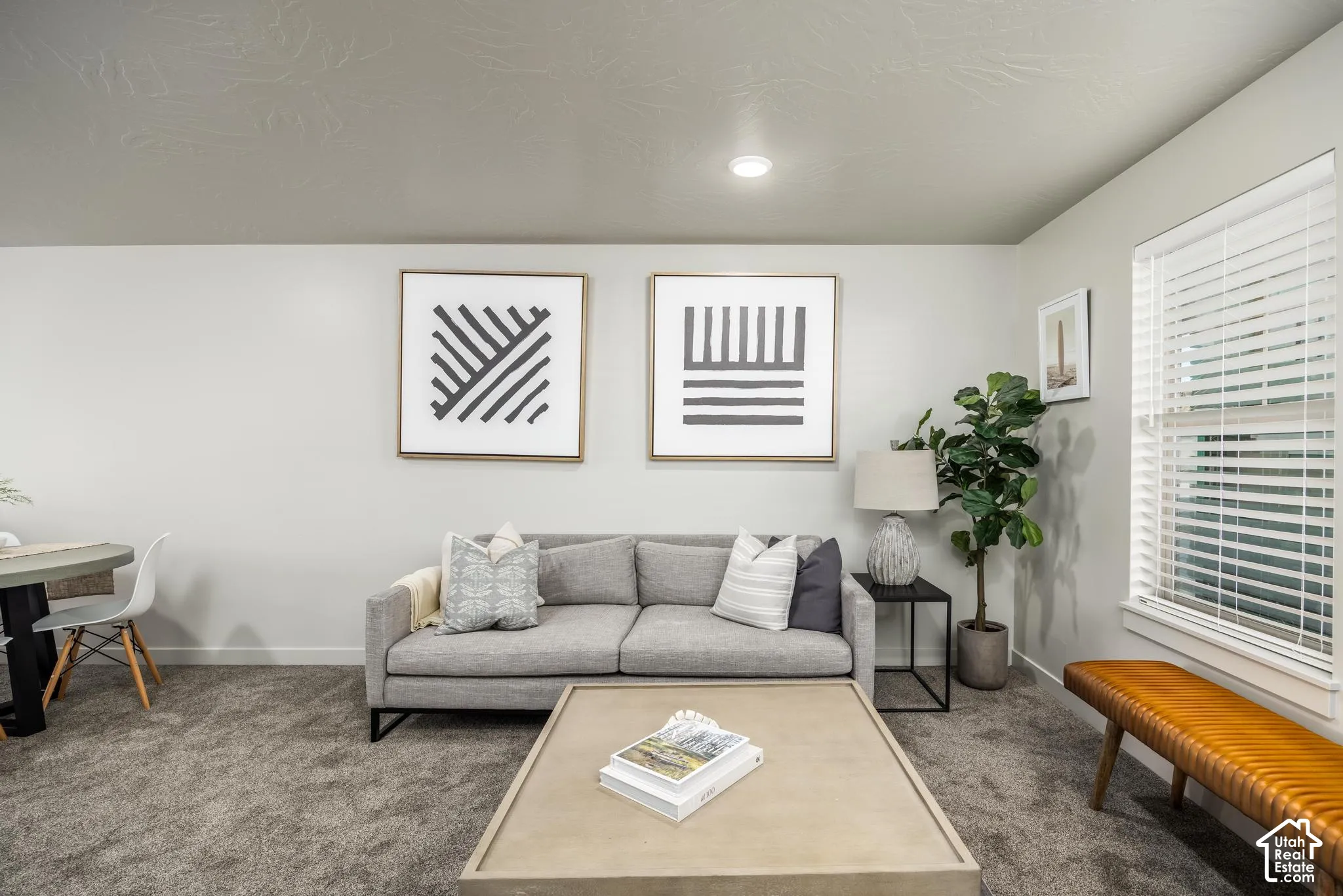 Neutral-toned wall paint, recessed lighting, carpeted flooring, and horizontal slat window blinds